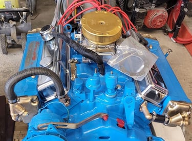 a blue engine with a gold top and a gold top