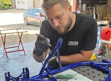 a man working on a kart frame