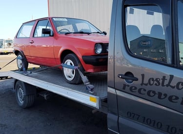 car collected from auction on recovery truck