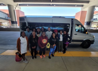 Satisfied customers in front of our high-roof Sprinter van after a tour