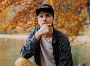 Marc Brunnert sitting on a pile of leaves