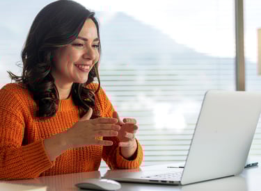 a woman sitting at a desk with a laptop