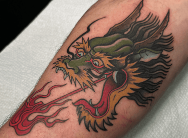 japanese style tradtional dragon head tattoo breathing fire