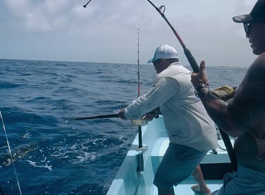 a man fishing in the ocean with a fishing rod