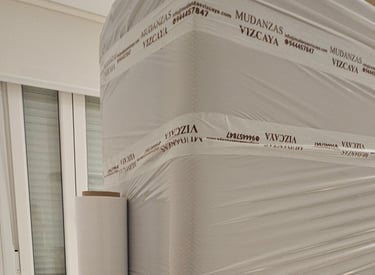 a person holding a box spring mattress on a bed