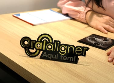 a woman sitting at a table with a invisible teeth aligner in front of her