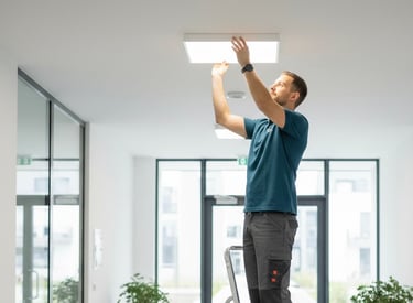 a man standing on a ladder ladder to reach the ceiling