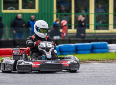 a person in a helmet and helmet on a race track