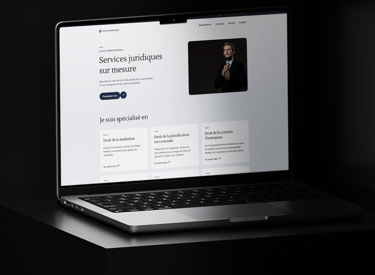 A laptop screen displaying a webpage of David Aebischer