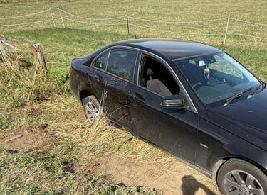 a car that is stuck in ditch being winched out