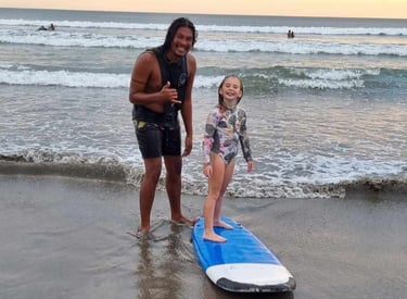 a woman and her daughter standing in the water