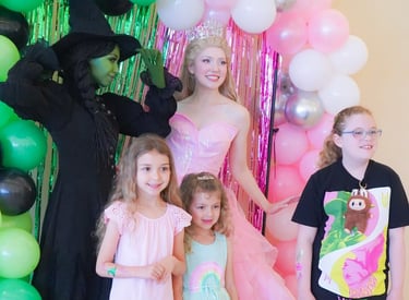 Elphie and Glinda pose for a photo with guests