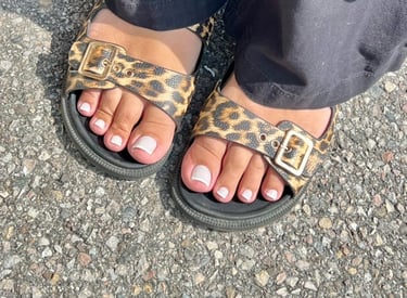 a person wearing a leopard print sandals and a leopard print sandals