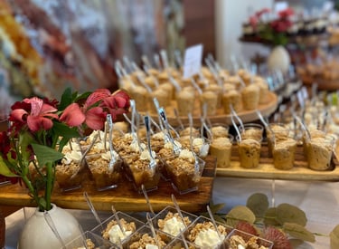 Food display of miniature desserts, fresh florals and food labels