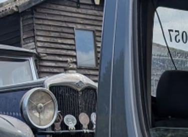classic car on the back of a recovery truck