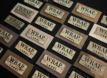 a bunch of leather and metallic labels that read "WRAP Label"