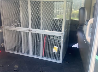 a van with a cage caged in to a cage