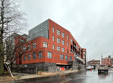 A photograph of a red brick apartment building