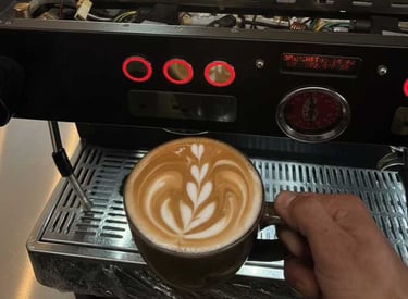 Specialized technician performing internal maintenance on a commercial espresso machine in a local c