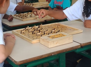 a group of children playing chess in a classroom