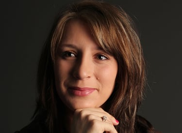 a woman with a brown jacket and a white shirt