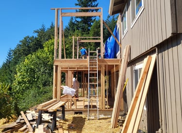 2-story addition on a house being framed.