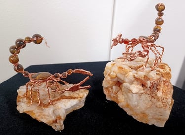 Wire wrap scorpion sculptures: copper, tiger's eye, and fire agate.
