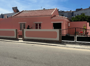 a pink house with a pink house in the background