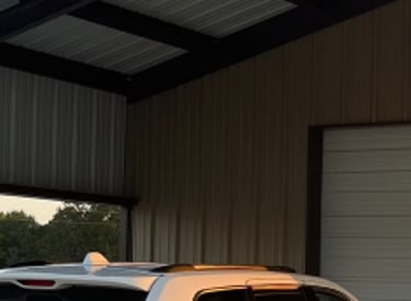 Covered carport with wooden beams.