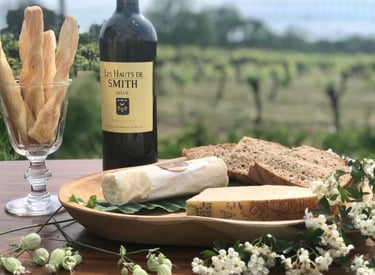 a bottle of wine and breadstickers on a table