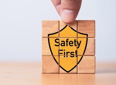 Building blocks with the graphic of a yellow shield saying "Safety First" on the front