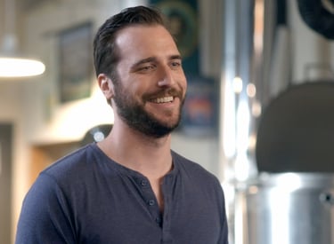 a man with a beard smiling