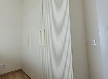 Bespoke wardrobe with fluted fronts adding texture and depth for a soft, elegant look