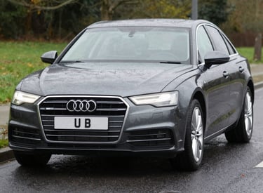 A sleek sedan parked by a scenic road ready for a self-drive adventure.