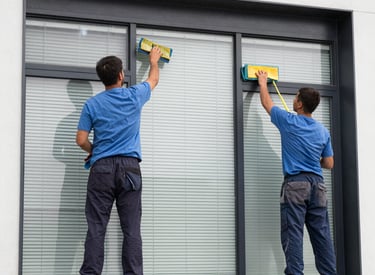 Cleaning crew washing windows of a modern apartment building