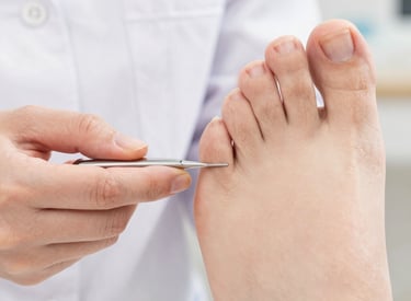 Close-up of a podiatrist examining a patient's foot with specialized tools in a modern clinic.