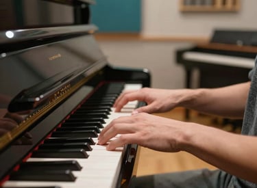 A clean, modern North American music studio with a high-end piano. A pair of hands is shown playing the keys in a warm, inviting setting with soft teal accents in the background.