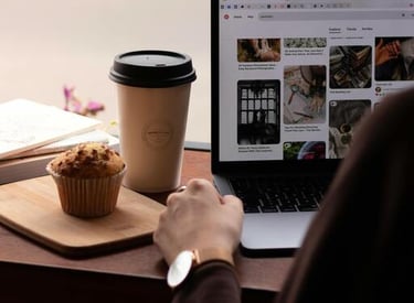 Una persona está navegando por Toty Shopping en un portátil en una cafetería, con una taza de café