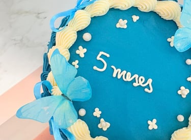 a cake with a blue and white cake with a name on it