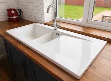 "White ceramic 1.5 bowl inset kitchen sink fitted with a chrome mixer tap in Kidlington, Oxford.