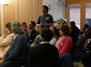 A diverse group of professional adults attending an engaging workshop and networking event.