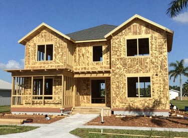 A skilled craftsman carefully installing luxury finishes inside a modern home under construction.
