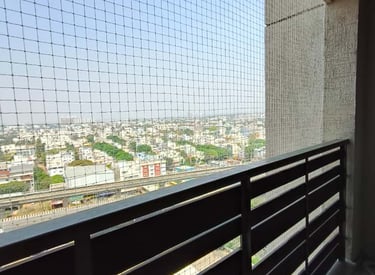 Close-up of a sturdy anti pigeon net installed on a balcony in Kodambakkam.