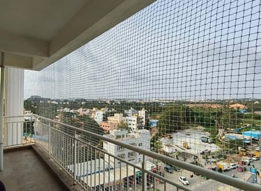 Anti-pigeon netting covering a commercial building's open areas.