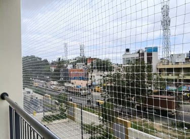 Close-up of a securely installed balcony safety net on a high-rise apartment in Vizag.