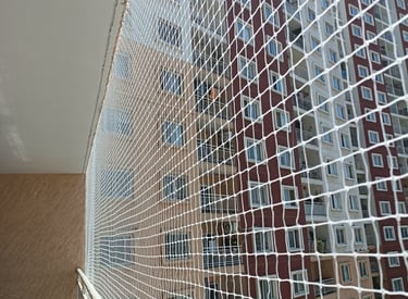 Close-up of a sturdy pigeon net securely fitted on a balcony railing.