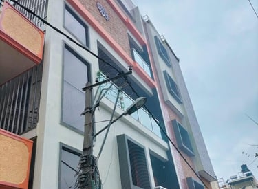 A panoramic view of Haralur skyline with several buildings fitted with safety nets.