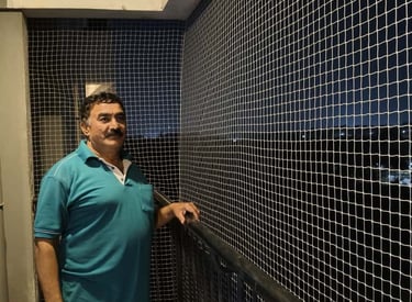 Finished installation showing clean edges and secure netting on a balcony.