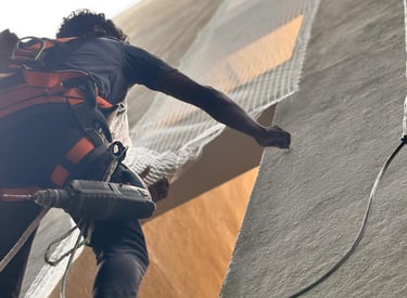 Close-up of a technician installing a safety cover over an apartment duct in Velacherry.