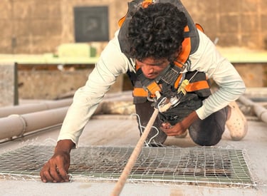 Staff installing safety nets on a balcony in HSR Layout, Bengaluru.